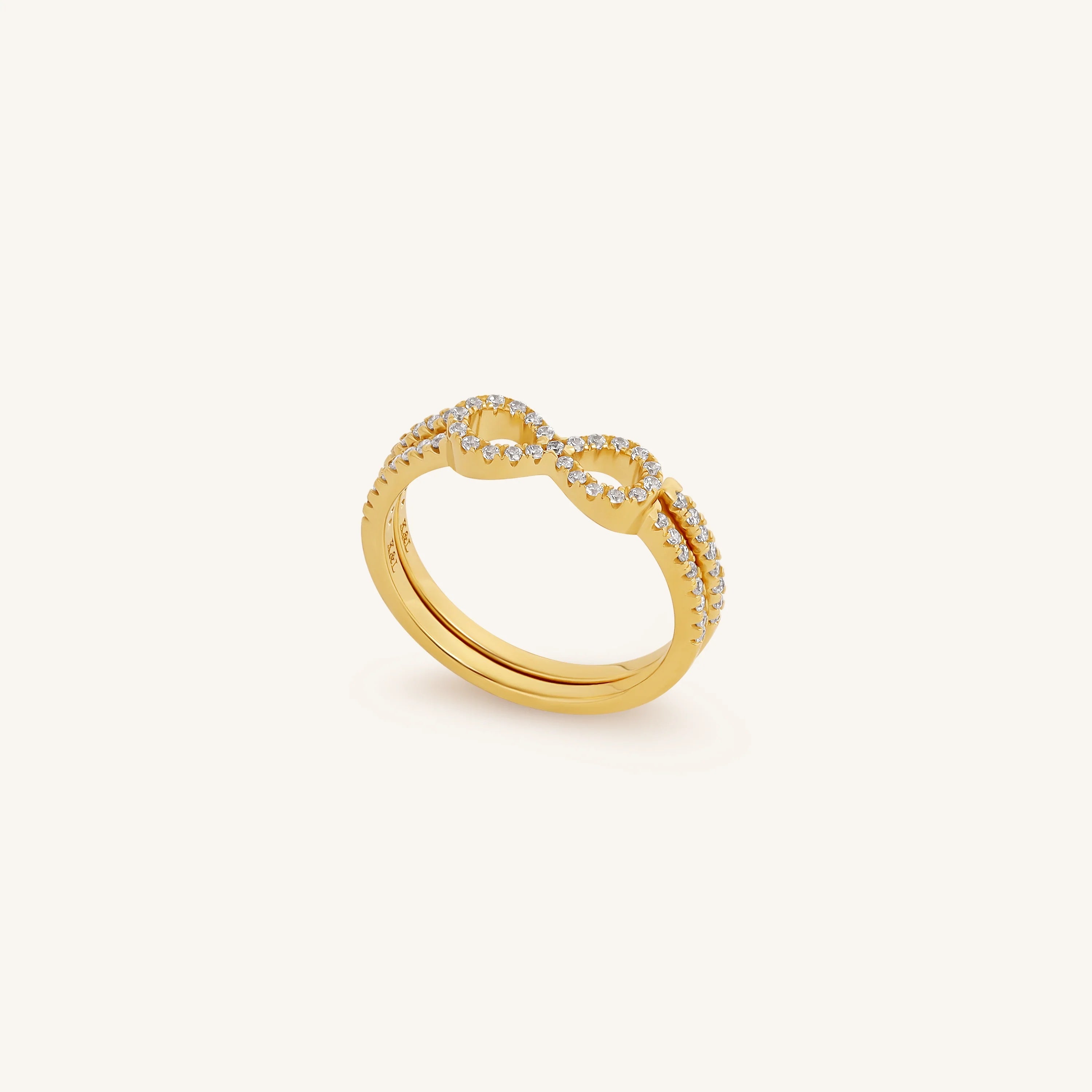 Gold ring with diamond accents on a white background