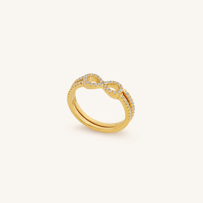 Gold ring with diamond accents on a white background